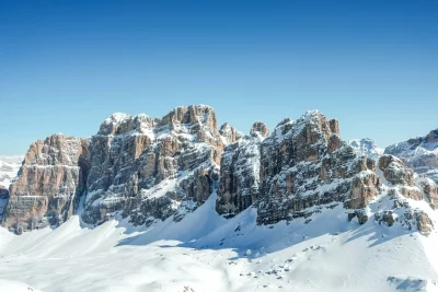 Winter Alpine Landscape: Snow-Covered Mountains Under Clear Blue Sky image