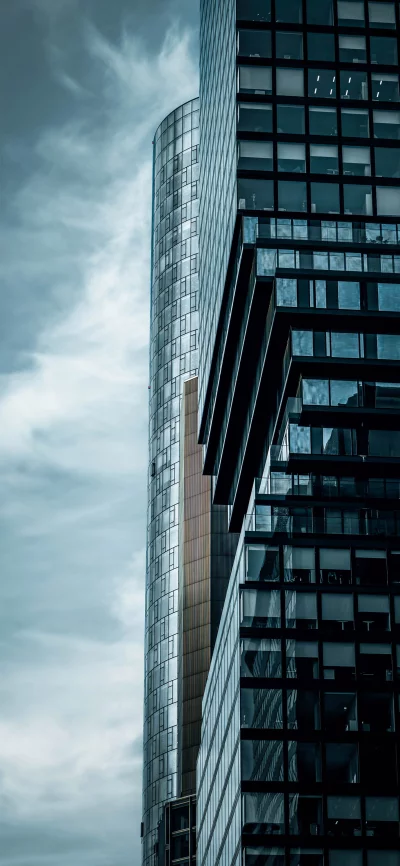 Modern architecture with glass facades against a dramatic sky