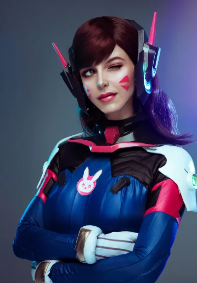 Playful D.Va Cosplayer Winking in Iconic Gaming Headset Portrait image