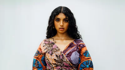 Stunning Young Woman in Vibrant African Print Dress Posing Confidently image