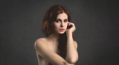 Pensive Young Woman with Hand on Face and Intense Gaze image
