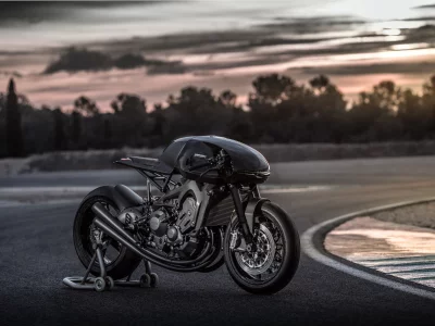Sleek Black Custom Cafe Racer Motorcycle on Race Track at Golden Hour image