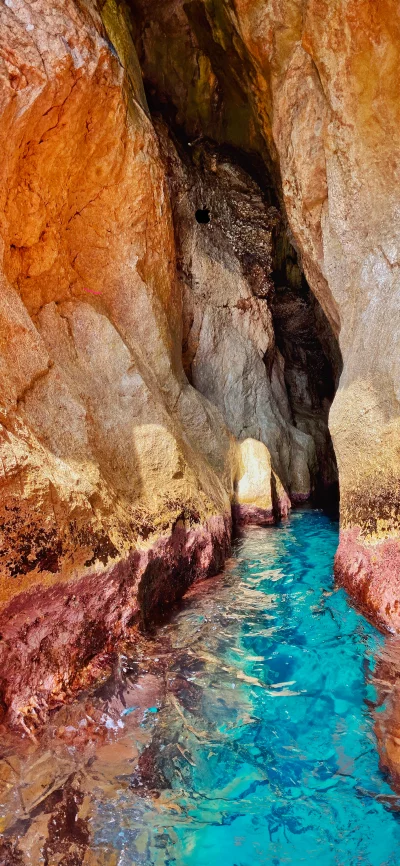 Vibrant Turquoise Waters Flowing Inside a Mysterious Sea Cave Grotto Entrance image