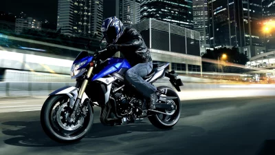 Dynamic Motorcycle Rider Speeding Through Illuminated City at Night image