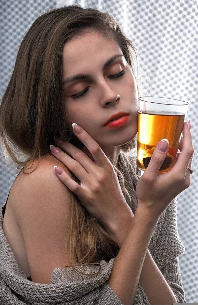 Serene Woman Enjoying a Warm Beverage with Closed Eyes and Delicate Hands image