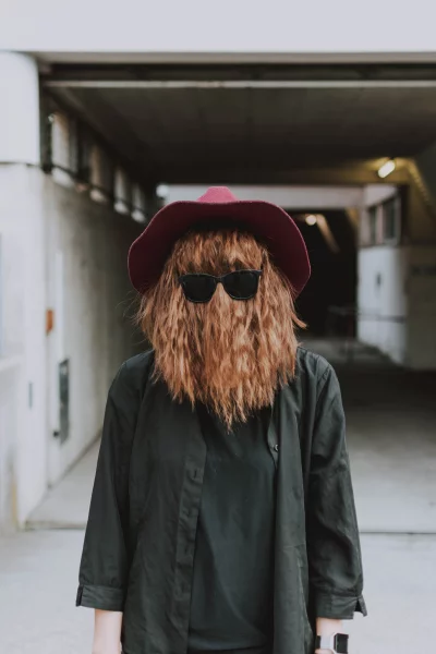 Woman wearing a red hat and sunglasses