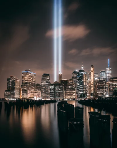 Iconic Tribute in Light illuminates Lower Manhattan skyline at night with reflections on water image