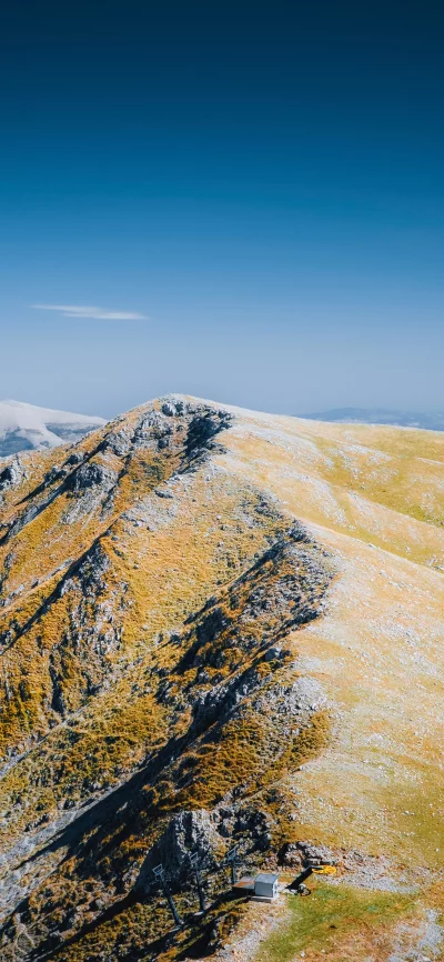High Alpine Peaks with Golden Autumn Grass and Remote Ski Lift Base image