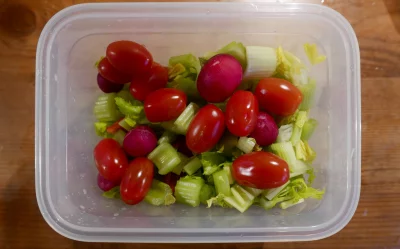 Fresh Vegetable Salad in Plastic Container with Cherry Tomatoes, Celery, Radishes image