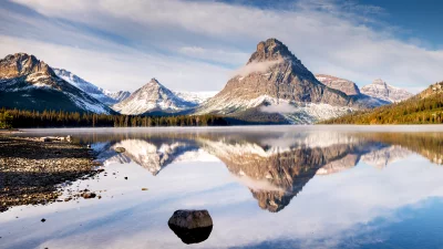 Majestic Mountain Lake Reflects Snow-Capped Peaks Under Serene Sky image