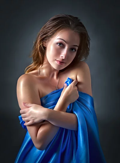 Sensual Young Woman Draped in Blue Silk Fabric Studio Portrait image
