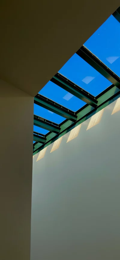 Modern architectural design with a skylight revealing a clear blue sky