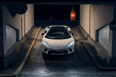 Sleek White Luxury Sports Car Emerging from Dark Tunnel Cinematic Wallpaper image