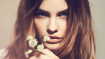 Close-up Portrait of Serene Woman with Blue Eyes and White Flowers image