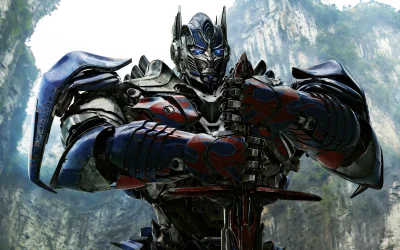 Iconic Optimus Prime Robot in Battle Armor Wielding a Powerful Sword Against a Rugged Mountainous Backdrop image