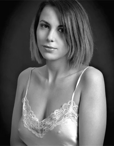Monochrome Portrait of Young Woman in Lace Top with Serene Gaze image