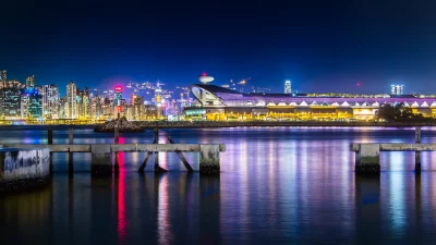 Hong Kong Cityscape at Night with Illuminated Convention Centre and Waterfront Reflections image
