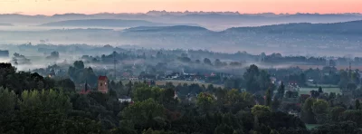 Dawn Mist Panorama: European Village Nestled in Foggy Mountain Landscape image