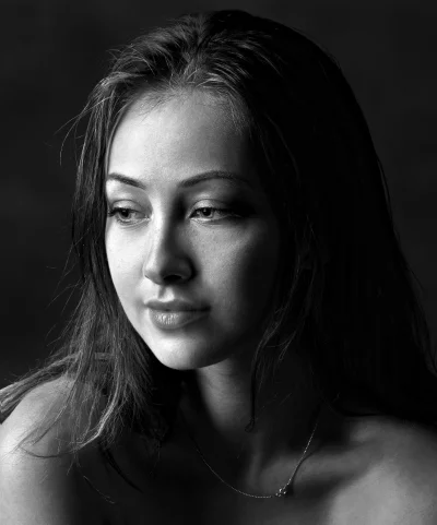 Dramatic Black and White Portrait of Pensive Woman with Long Hair, Subtle Lighting image