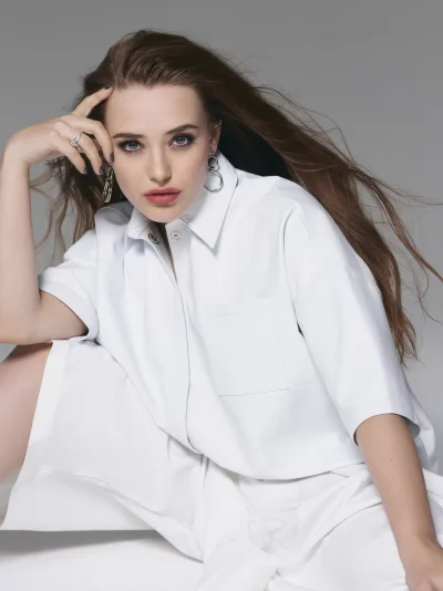 Contemplative Woman in White Shirt with Hand on Head and Flowing Brown Hair image