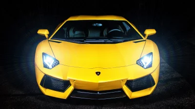 Front View of a Striking Yellow Supercar with Bright Headlights at Night image
