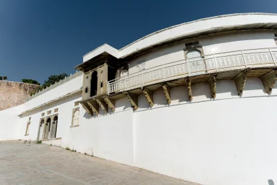 Historic White Palace with Ornate Balconies Under a Clear Blue Sky image