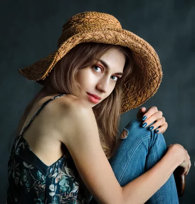 Elegant Young Woman in Straw Hat and Floral Camisole Posing image