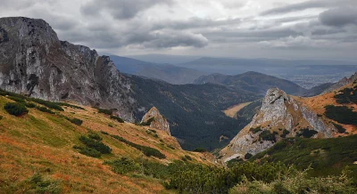 Rugged Mountain Valley Landscape Under Dramatic Autumn Cloudy Sky Panorama image