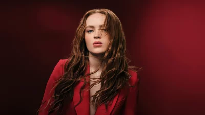 Young Woman with Red Hair and Blue Eyes in Red Blazer, Intense Gaze image