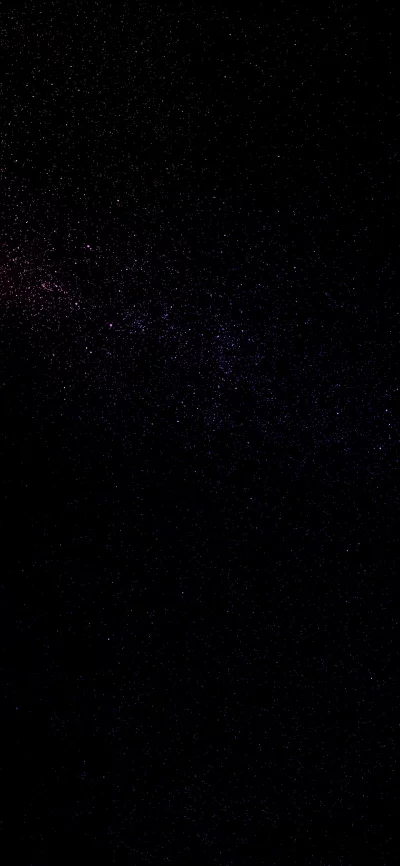 Abstract dark background with subtle pink and purple glowing dust particles