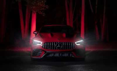 Powerful Red Mercedes-AMG GT Sports Car with Intense Headlights in Dark Mysterious Night image