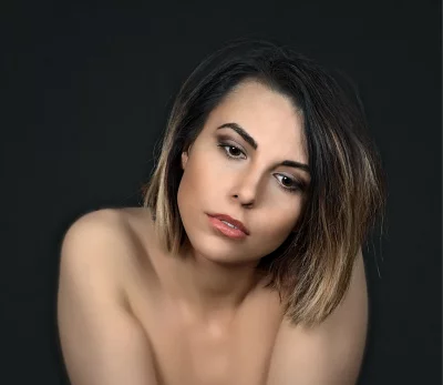 Beautiful Young Woman with Ombre Hair and Thoughtful Gaze Against a Dark Studio Backdrop image