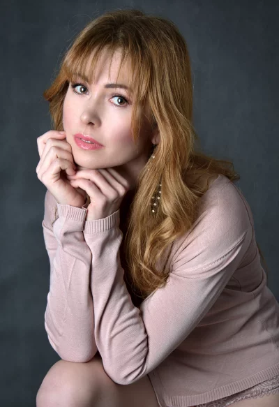 Elegant Young Woman with Pensive Gaze and Clasped Hands Portrait image