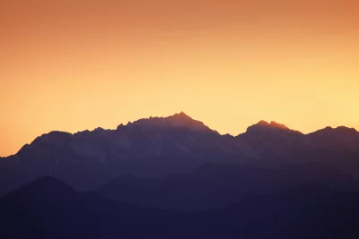 Golden Hour Glow Over Layered Mountain Peaks Landscape Scenic image