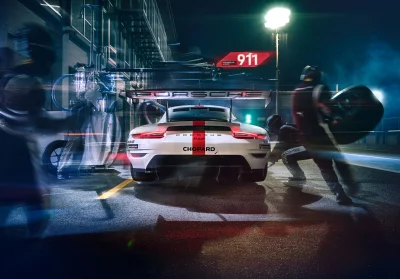 Porsche 911 GT3 R Race Car in Dynamic Night Pit Stop Action image