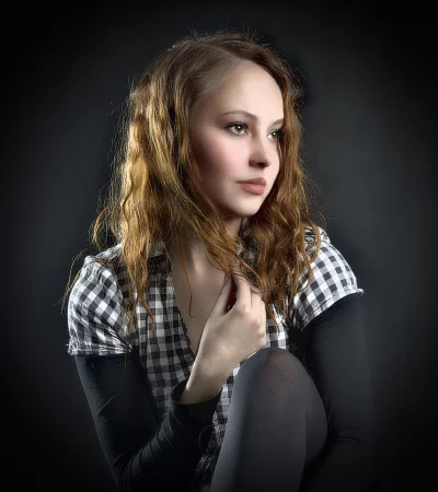 Pensive Young Woman with Wavy Hair in Casual Plaid Shirt Portrait image
