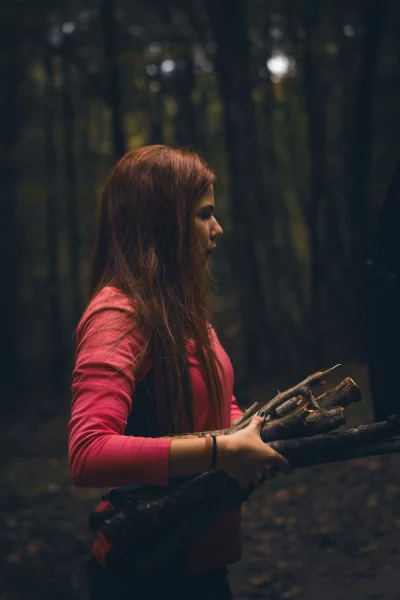 Redhead Gathering Natural Wood Branches in a Serene, Deep Forest Environment