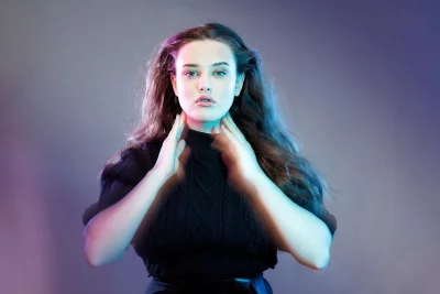 Intense Young Woman Portrait with Dynamic Blue and Pink Neon Lighting image