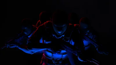 Tactical Squad Advancing with Assault Rifles in Dramatic Red Blue Light image