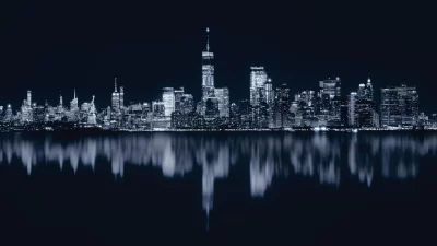 New York City Skyline at Night with Iconic Skyscrapers Reflected on Water image