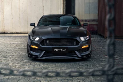 Matte Black Ford Mustang Sports Car in Industrial Urban Setting image