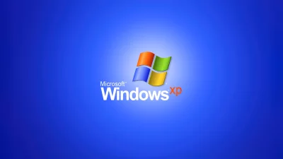 Classic Microsoft Windows XP Logo on Vibrant Blue Gradient Background image