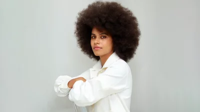Confident Young Woman with Natural Afro Hair Posing in White Shirt Studio image