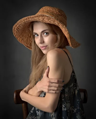 Beautiful Young Woman in Straw Hat Looking Over Shoulder image