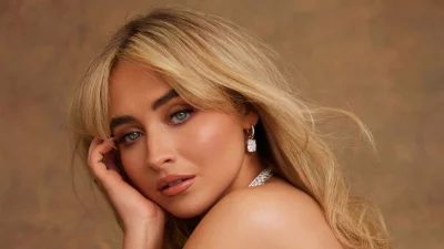 Glamorous Blonde Woman with Blue Eyes, Radiant Skin, and Sparkling Diamond Earrings image
