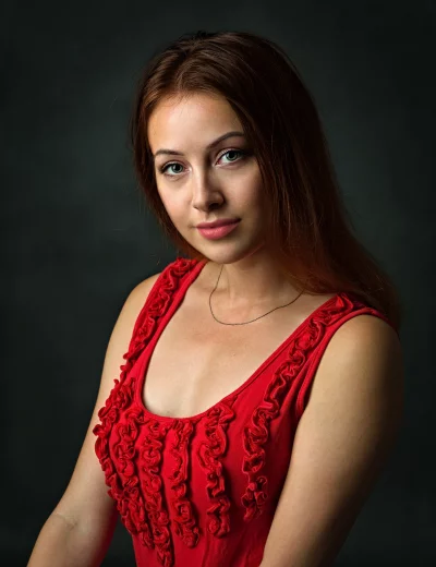 Captivating Young Woman in Red Top with Serene Gaze image