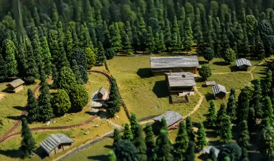 Miniature Model Forest Village with Winding Train Track and Cabins image