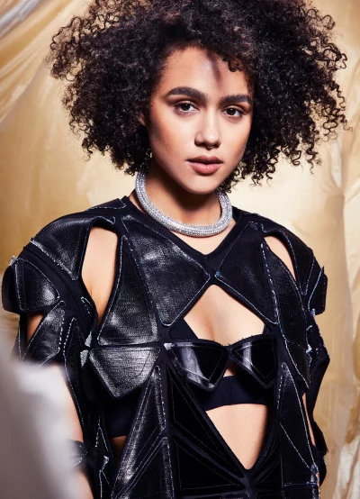 Nathalie Emmanuel Posing in Modern Black Geometric Top Cinematic Wallpaper image