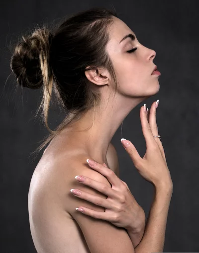 Beautiful Young Woman with Elegant French Manicure Posing Serene image
