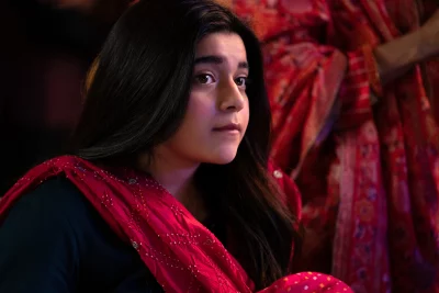 Portrait of a pensive young South Asian woman in a vibrant red dupatta with dark hair image